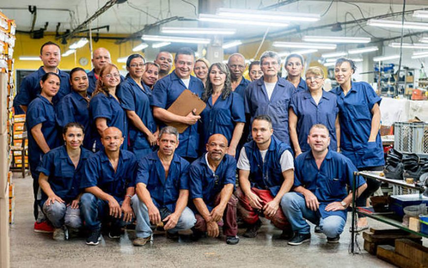 Why should a manufacturing company provide uniforms for its factory workers?